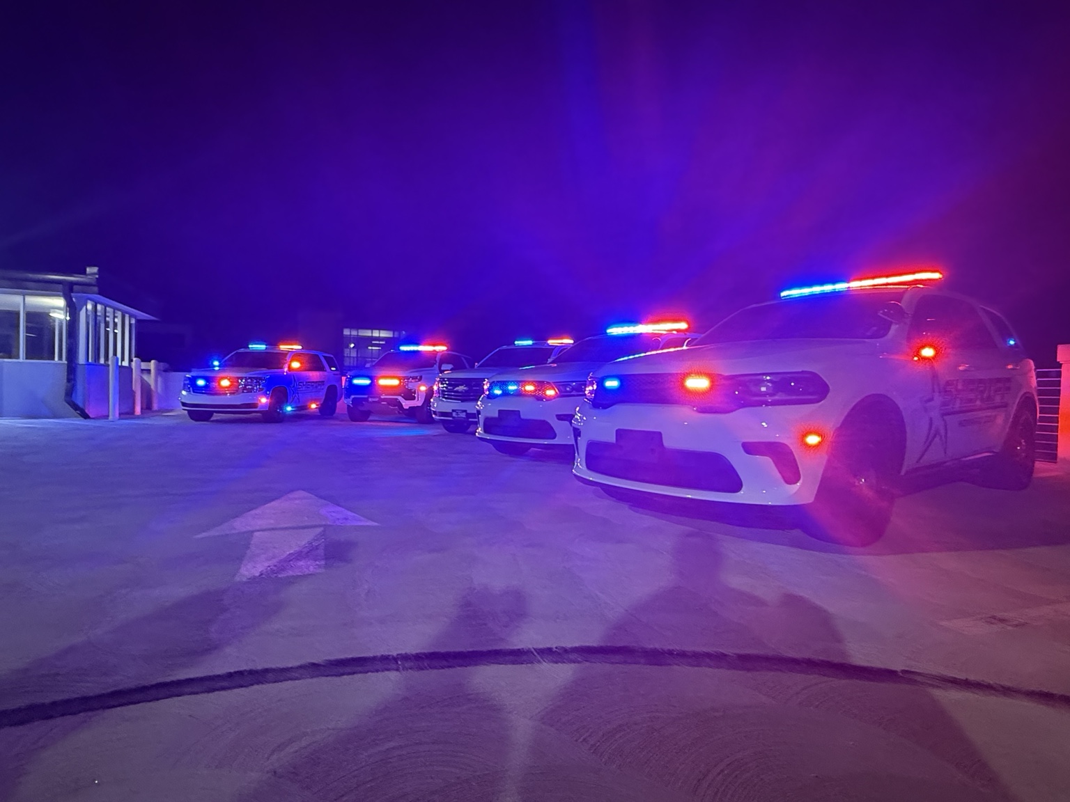 Completed public safety fleet displaying red and blue emergency warning lights at night