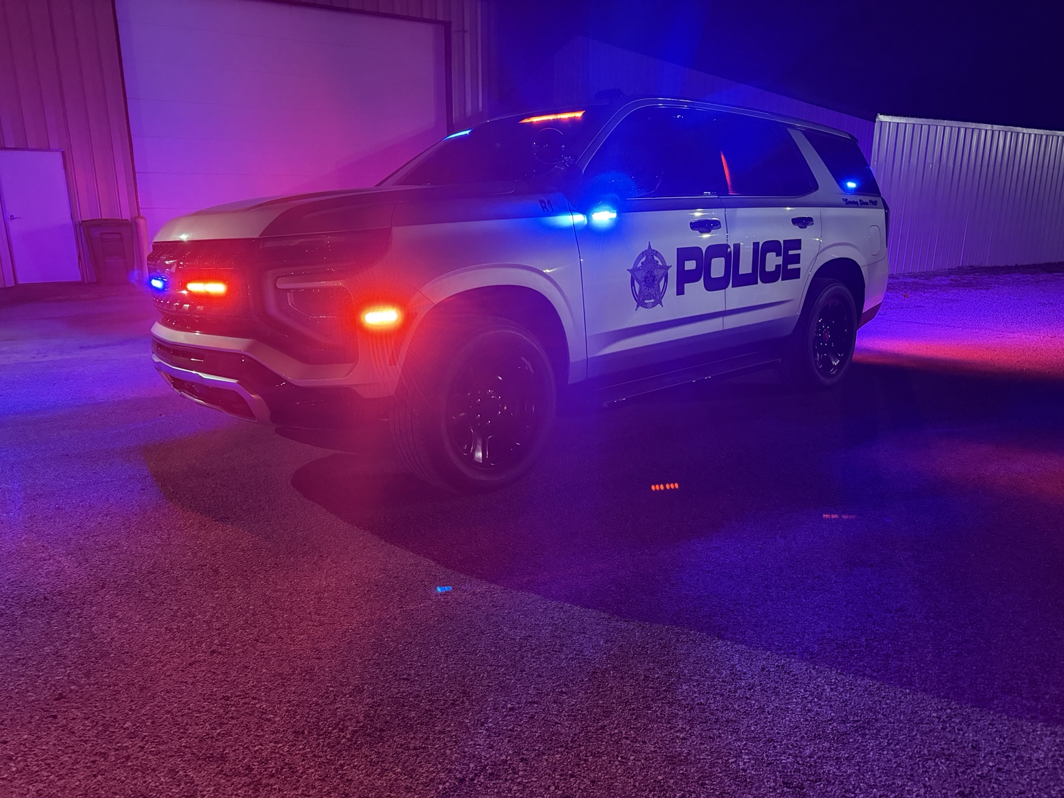 Completed police Chevrolet Tahoe with Federal Signal emergency lighting activated at night